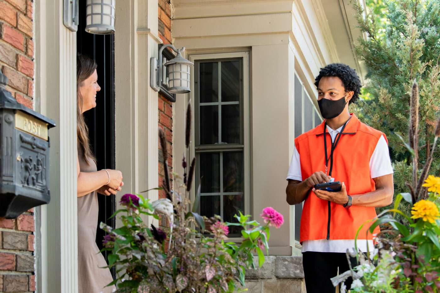 Door-to-door canvasser discussing charitable donation with homeowner
